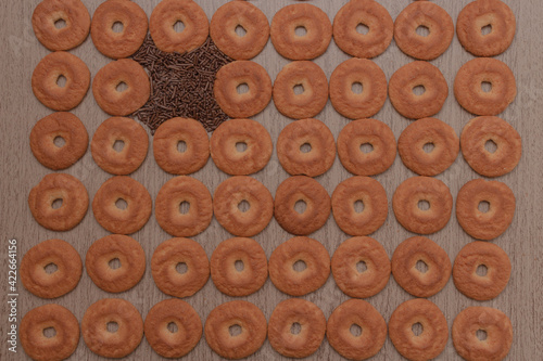 Cookies on wooden table with chocolate sprinkles photo