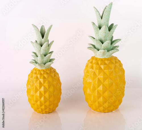 Two ceramic pinneaples in a white background