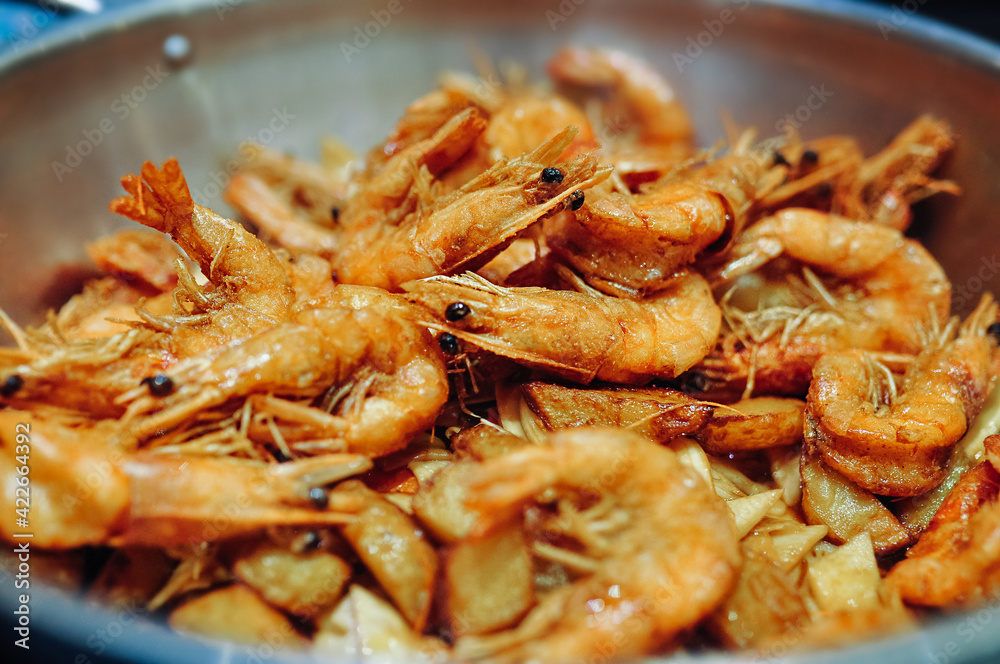 selective focus large dish with fried shrimp in batter and spices. Asian seafood dishes. eating protein foods
