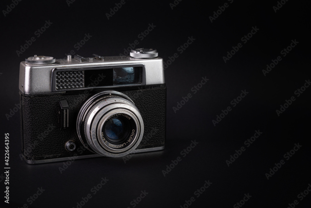 Old analog camera, in a black background Old analog camera, in a black background