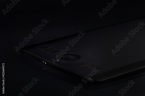 Detail of a graphic tablet, in low key