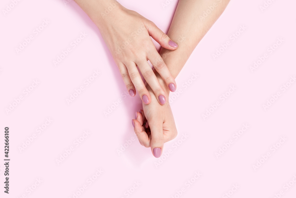 Beautiful female hands on a pink background. Beautiful female hands on a pink background.