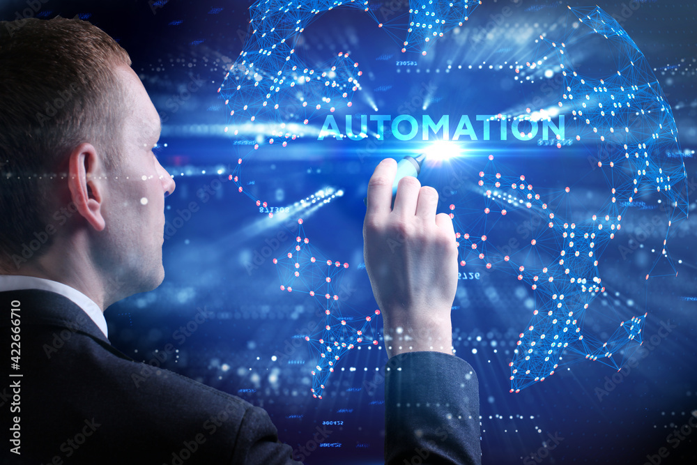 Business, Technology, Internet and network concept. Young businessman working on a virtual screen of the future and sees the inscription: Automation Business, Technology, Internet and network concept. Young businessman working on a virtual screen of the future and sees the inscription: Automation