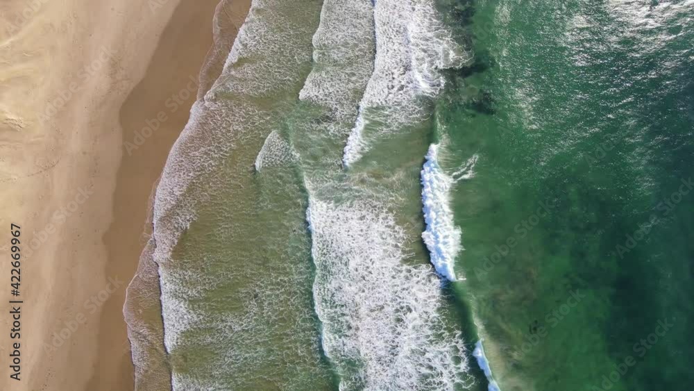 Aerial view of waves rolling into coastline Aerial view of waves rolling into coastline