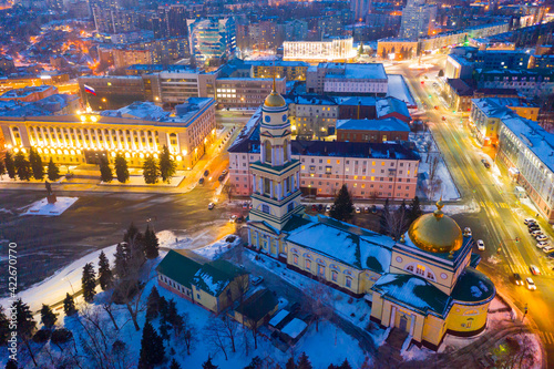 View from drone of illuminated Cathedral of Nativity of Christ on main square in Russian city of Lipetsk on winter evening..