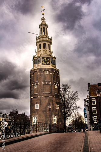 old tower near a bridge and over the canal in Amsterdam