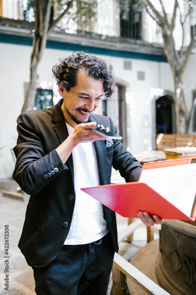 Fototapeta premium hispanic man working and call by phone in a creative office in Mexico city