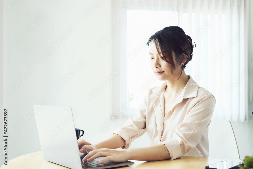 new normal, a businesswoman useing computer to work for a company Via the internet on your desk at home new normal, a businesswoman useing computer to work for a company Via the internet on your desk at home