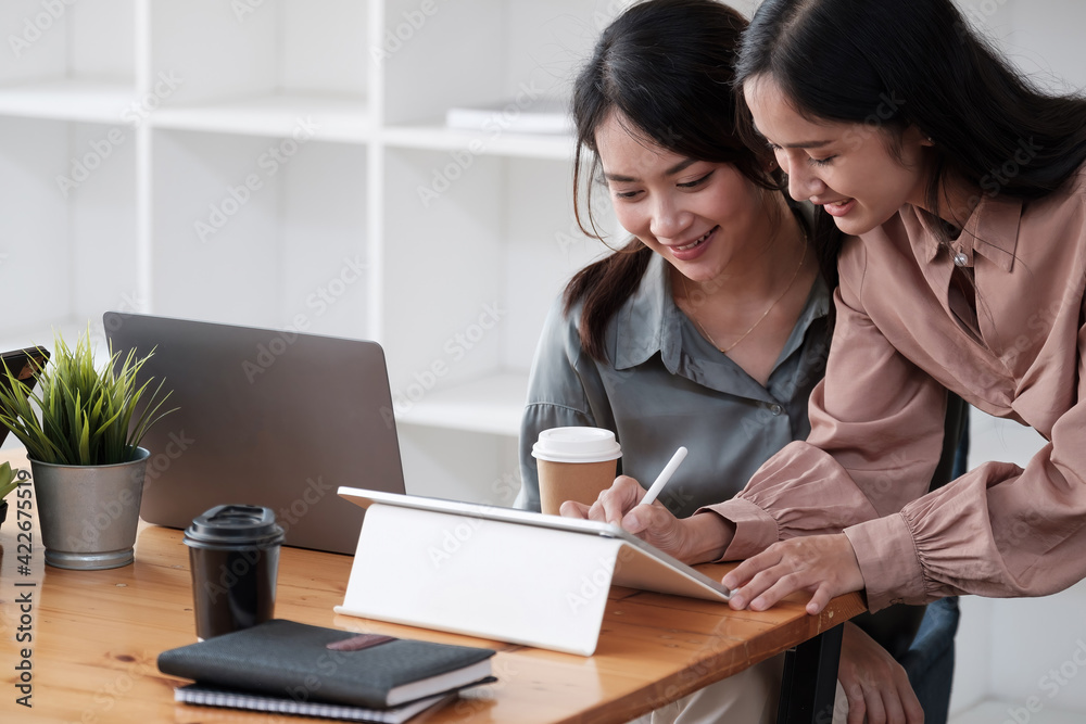 Two beautiful bussineswomen smiling happy. Working together speaking at the office. Two beautiful bussineswomen smiling happy. Working together speaking at the office.