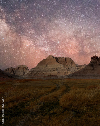 An amazing view of the Milky Way above desert sand formations  Badlands National Park. An awe night sky view with our galaxy.  An idyllic and motivational scenery.