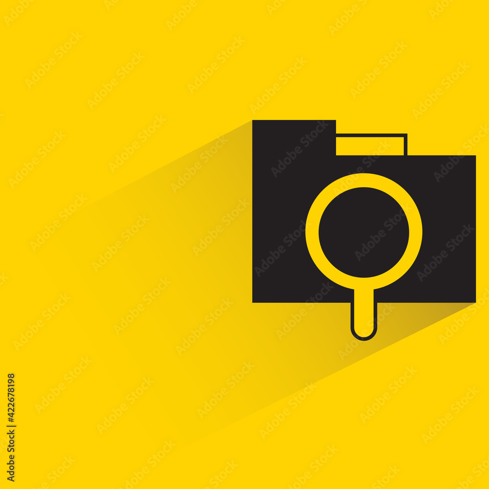folder and magnifier with shadow on yellow background folder and magnifier with shadow on yellow background