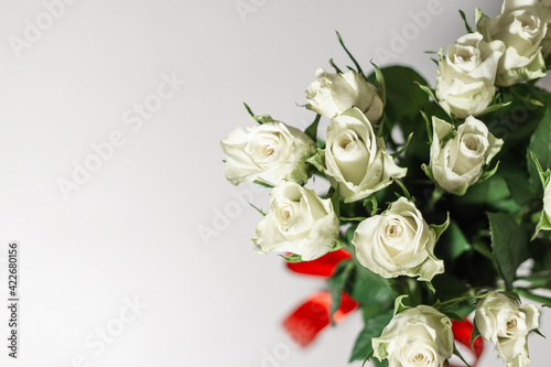 A bouquet of white tea roses on a light table background. Top view. selective focus