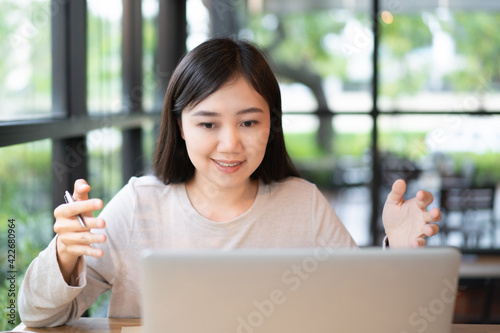 Asian beautiful working woman doing her work and drink in the coffee shop.