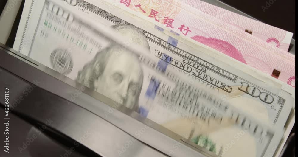 US dollar bill vs China yuan, new econ super power. Bank notes in money counter