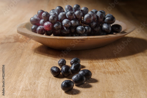 Grapes fruit in the wood bowl
