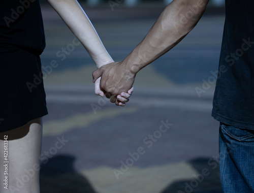 Close up view of romantic couple in love holding hands. valentine's day. Love story and Romantic concept.