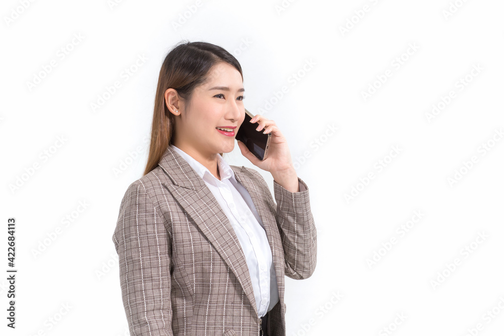 Asian business woman in formal suit with white shirt is calling telephone and opens document file or clipboard to check data. Asian business woman in formal suit with white shirt is calling telephone and opens document file or clipboard to check data.