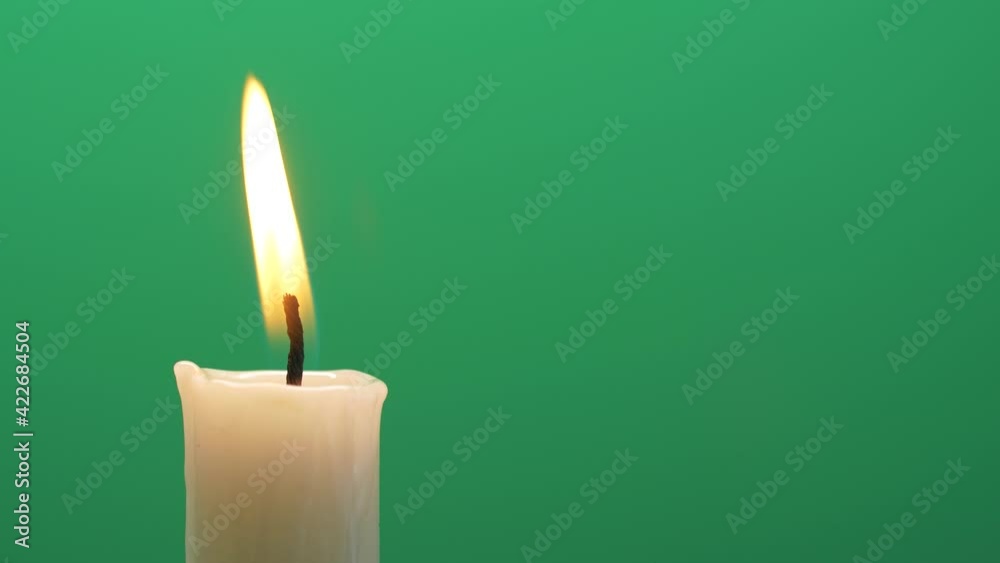 Closeup candle fire flame burning on chroma key green screen background 4K video Closeup candle fire flame burning on chroma key green screen background 4K video