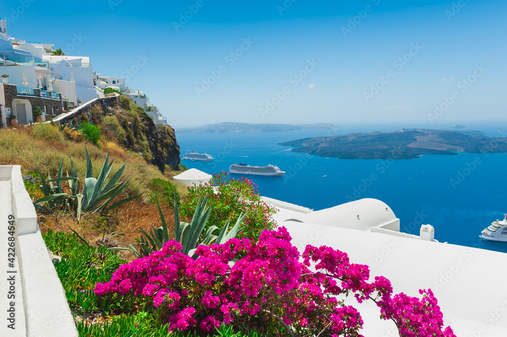 White architecture on Santorini island, Greece. Flowers on the terrace with sea view. Travel destinations concept