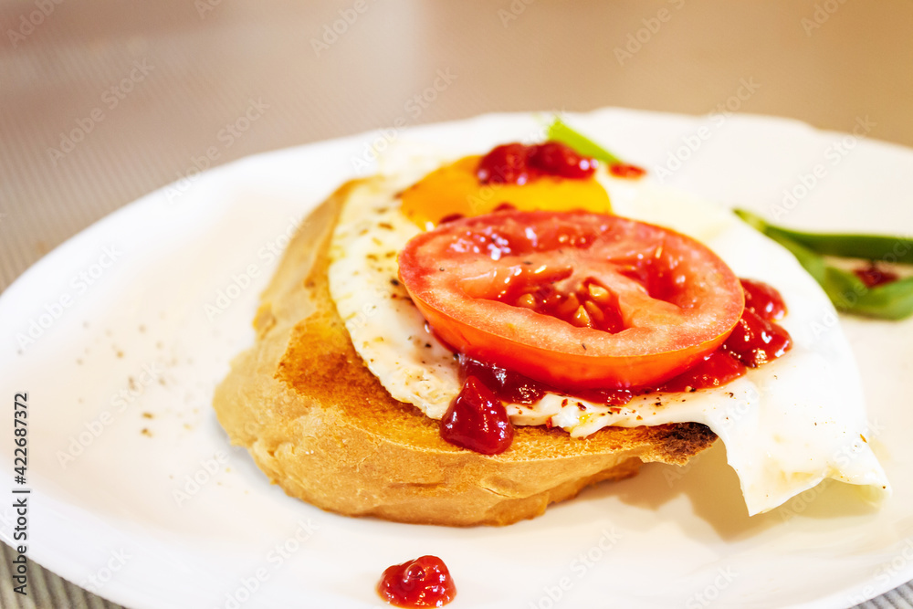 Fried egg with tomato, onion and tomato paste on toast