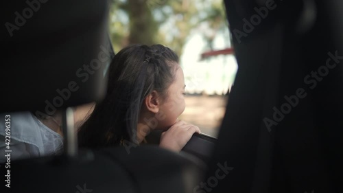 4K Happy Asian family having fun together with outdoor lifestyle activity on summer beach road trip holiday vacation. Child girl kid with mother sitting in the car and looking to beautiful sea beach.