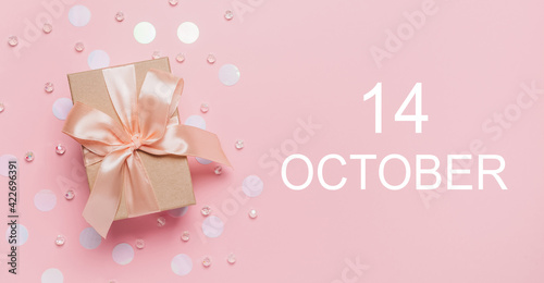 Gifts on pink background, love and valentine concept with text 14 October © Daria Lukoiko