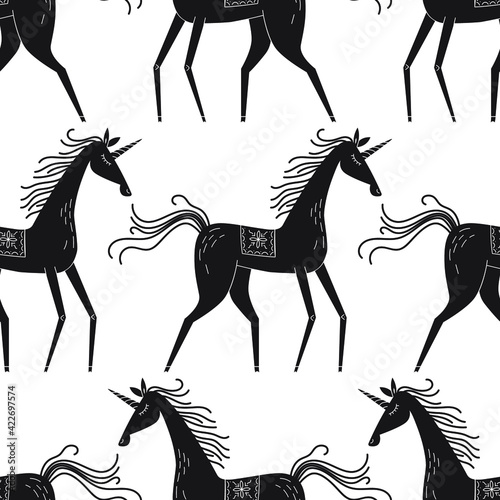 Seamless vector pattern with grapghic unicorns. Linocut style magic illustration photo