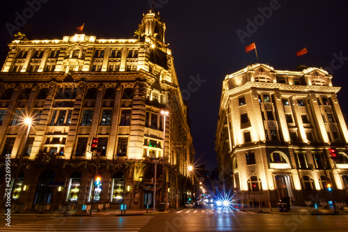 Historic building facades with red Chinese flags on top along Bund 