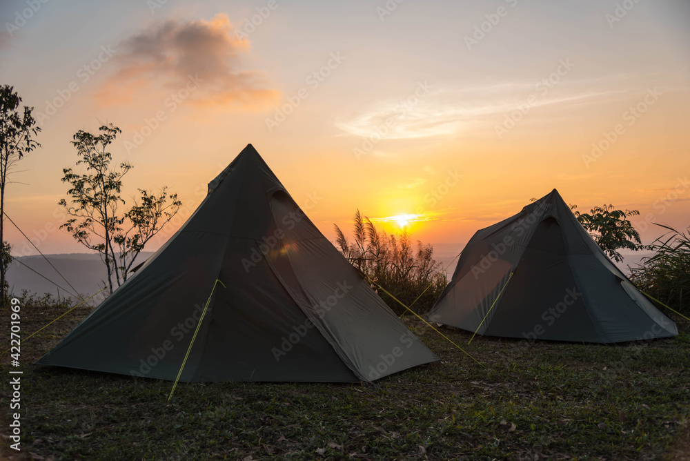 silhouette of camping tents with sunset view