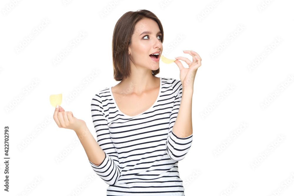 Beautiful young woman eating potato chips on white background Beautiful young woman eating potato chips on white background