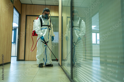 Fumigator sanitizing, cleaning and disinfection. Coronavirus pandemic professional control. photo