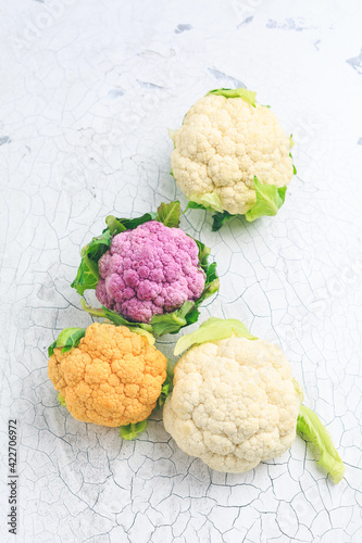 Organic colorful cauliflower on old kitchen table