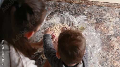 mother with baby make dough, top view. Mother prepares a child