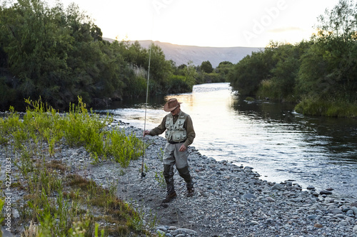 Fisherman on a riverbank in Patagonia