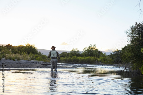 Fisherman walking in a river in Patagonia