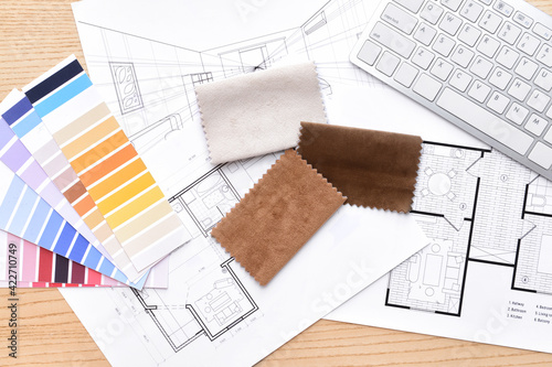 House plans, color palettes and fabric samples on wooden background