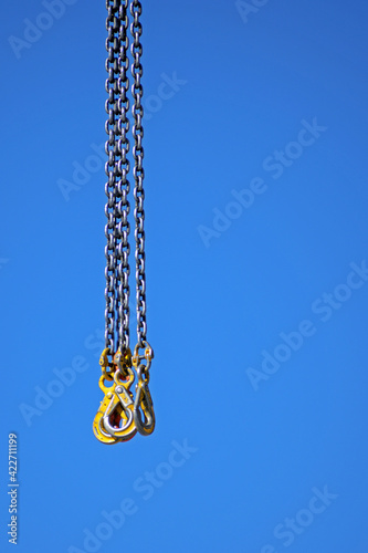 Slings of a construction crane on a blue sky background close-up