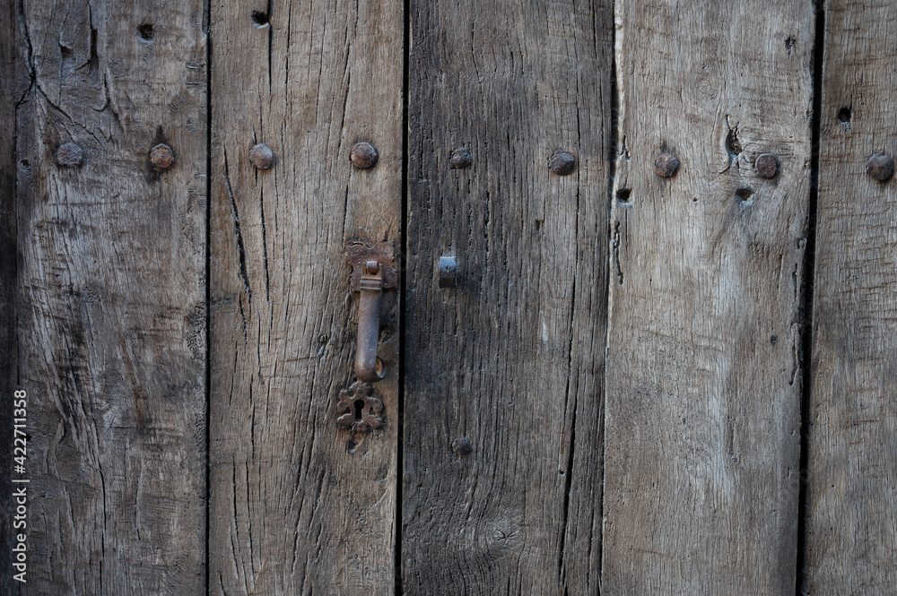 Detail of the keyhole of an old wooden door Detail of the keyhole of an old wooden door