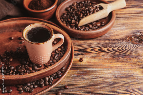 Cup of tasty hot coffee on wooden background