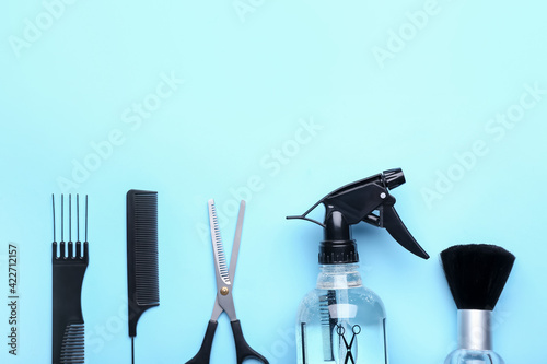 Set of hairdresser's tools on color background