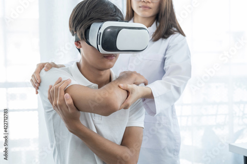 VR box with patient male, Female doctor doing physical therapy by extending the hand, the concept of technology helped the feeling as if a doctor came to treat at home