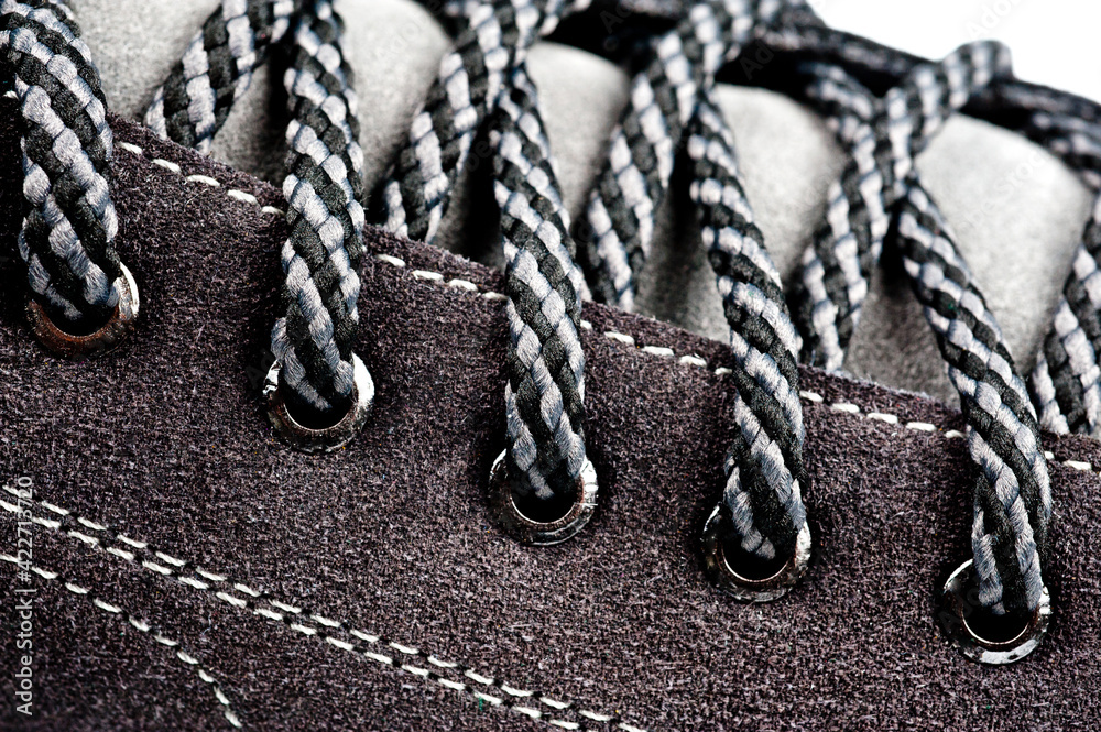 Men's gray-brown sports shoes laced with laces. Close-up shot.