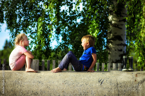 kids brother and sister play outdoors in summer, selective focus
