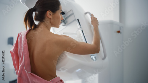 In the Hospital, Portrait Shot of Topless Multiethnic Female Patient Undergoing Mammography Screening Procedure. Healthy Adult Caucasian Woman Does Cancer Preventive Mammogram Scan in Radiology Room.