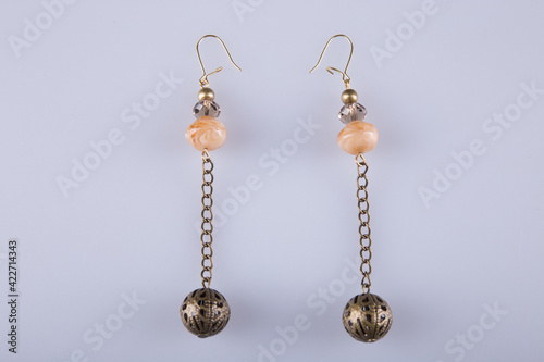 Beautiful earrings on a light gray background. Costume jewelry. 