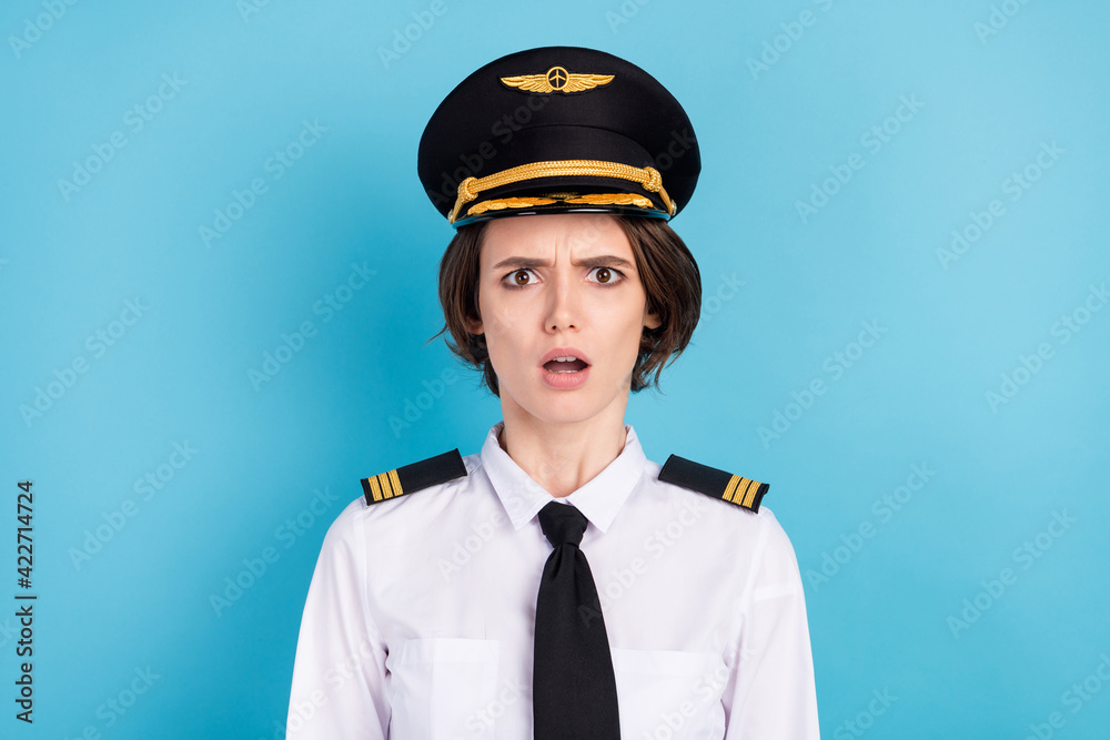 Photo of impressed nice brunette hair lady wear pilot uniform isolated on blue color background - obrazy, fototapety, plakaty 