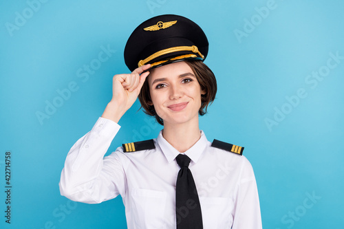 Fototapet Photo of optimistic nice brunette hair lady wear pilot uniform isolated on blue