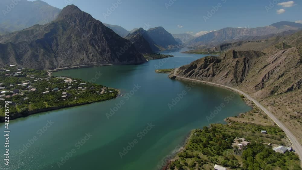 Aerial inspirational to travel Caucasus epic rural natural landscape. Country village, traditional alpine aul on banks Sulak canyon surrounded by high mountains. Serpentine winding river. Road traffic Aerial inspirational to travel Caucasus epic rural natural landscape. Country village, traditional alpine aul on banks Sulak canyon surrounded by high mountains. Serpentine winding river. Road traffic