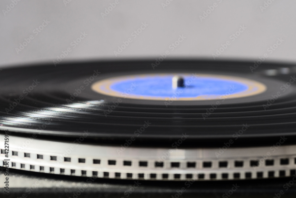 A black vinyl record on a turntable. Selective focus. A black vinyl record on a turntable. Selective focus.