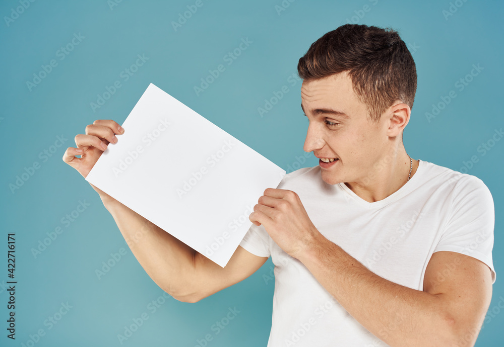 Happy man with white sheet of paper mockup advertisement poster Happy man with white sheet of paper mockup advertisement poster